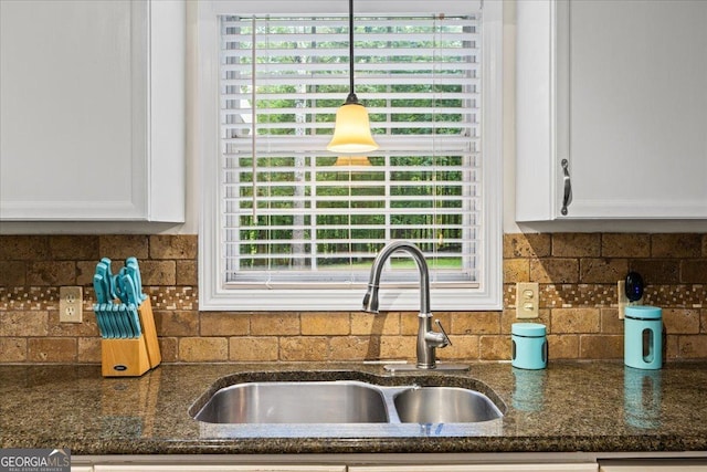 1154 Pinebrook Rd, Auburn, GA 30011 - kitchen featuring a sink, white cabinets, pendant lighting, dark stone countertops, and healthy amount of natural light