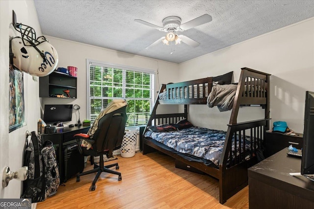 1154 Pinebrook Rd, Auburn, GA 30011 - bedroom featuring light wood finished floors, a textured ceiling, an office area, and a ceiling fan
