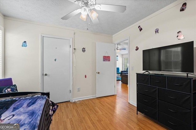 1154 Pinebrook Rd, Auburn, GA 30011 - bedroom featuring a textured ceiling, light wood-type flooring, baseboards, and a ceiling fan
