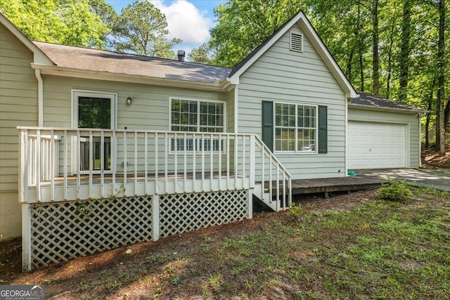 1154 Pinebrook Rd, Auburn, GA 30011 - back of house featuring a garage, roof with shingles, driveway, and a deck