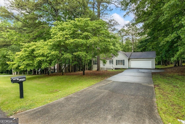 1154 Pinebrook Rd, Auburn, GA 30011 - view of front of house featuring driveway, an attached garage, and a front lawn