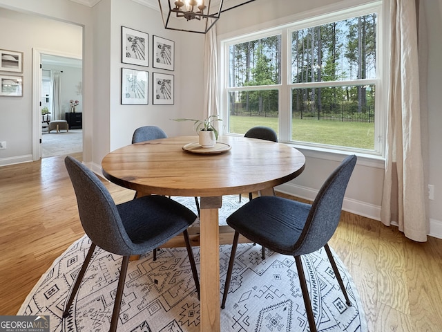 35 Perkins Cv, Senoia, GA 30276 - dining area with healthy amount of natural light, baseboards, light wood-style flooring, and crown molding