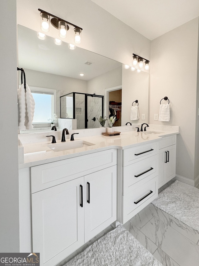 35 Perkins Cv, Senoia, GA 30276 - bathroom with double vanity, a stall shower, and marble look tiles