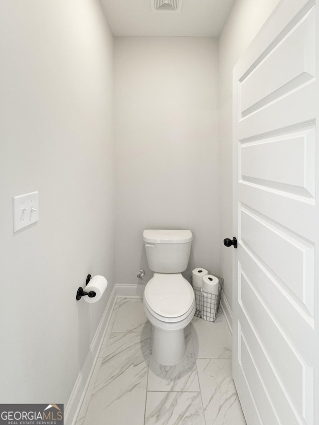 35 Perkins Cv, Senoia, GA 30276 - bathroom with toilet, marble look tile flooring, and baseboards