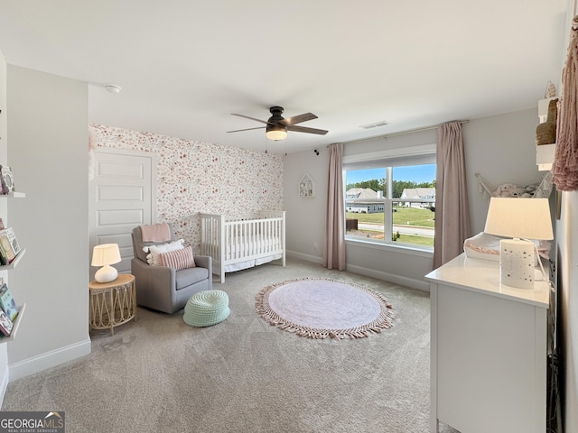35 Perkins Cv, Senoia, GA 30276 - bedroom featuring light carpet, a nursery area, baseboards, ceiling fan, and wallpapered walls