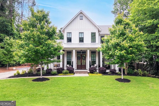 201 Dobbs Rd, Woodstock, GA 30188 - modern inspired farmhouse with board and batten siding, covered porch, a front lawn, and metal roof