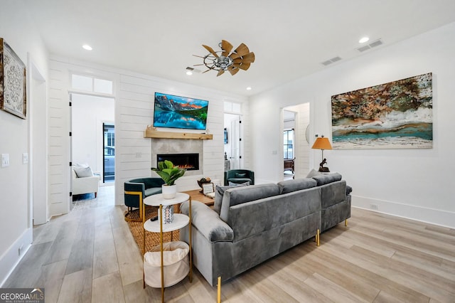 201 Dobbs Rd, Woodstock, GA 30188 - living area featuring a warm lit fireplace, light wood-style floors, baseboards, recessed lighting, and a ceiling fan