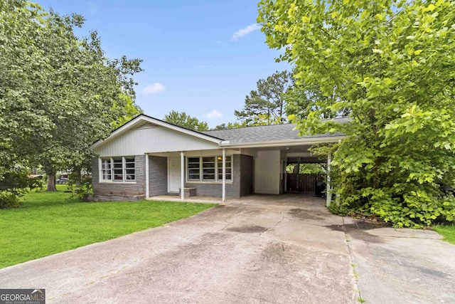 1176 Cardinal Rd NE, Conyers, GA 30012 - ranch-style house featuring driveway, a front lawn, an attached carport, and a shingled roof