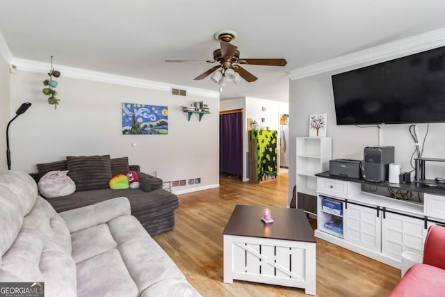 1176 Cardinal Rd NE, Conyers, GA 30012 - living room with ornamental molding, a ceiling fan, light wood-style floors, and baseboards