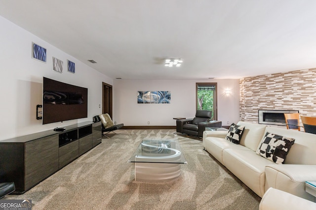 living area with carpet, a tile fireplace, and baseboards