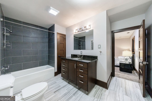 ensuite bathroom with toilet, vanity,  shower combination, and baseboards