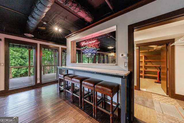 dining room with a dry bar and wood finished floors