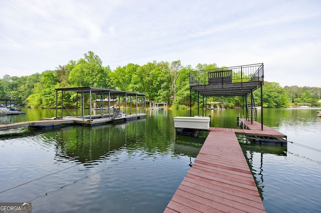 dock featuring a water view and a wooded view