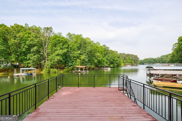 wooden terrace with a water view and a dock