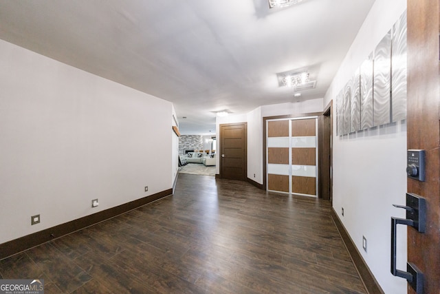 unfurnished room with wood finished floors and baseboards