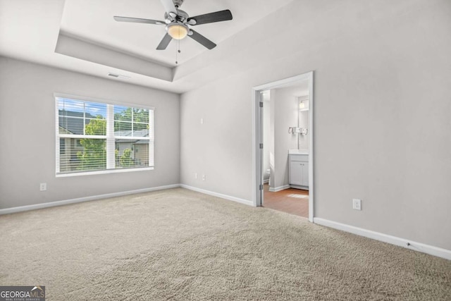 3181 Meadowstone Ln SW, Atlanta, GA 30331 - unfurnished bedroom with a tray ceiling, carpet, and baseboards