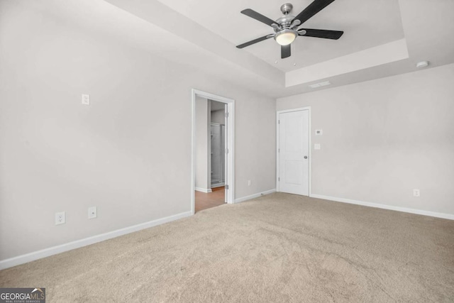 3181 Meadowstone Ln SW, Atlanta, GA 30331 - unfurnished room featuring a tray ceiling, carpet flooring, a ceiling fan, and baseboards