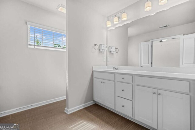 3181 Meadowstone Ln SW, Atlanta, GA 30331 - full bath featuring baseboards, double vanity, and wood finished floors