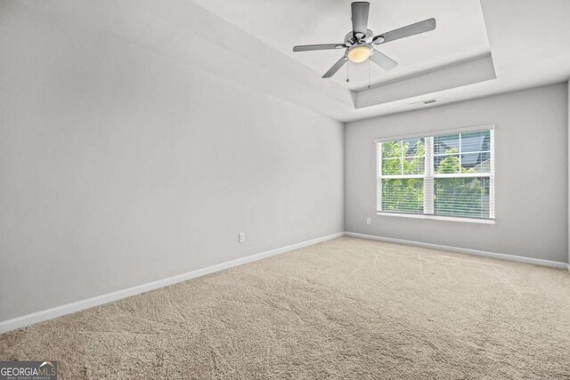 3181 Meadowstone Ln SW, Atlanta, GA 30331 - carpeted spare room featuring baseboards, a tray ceiling, and ceiling fan