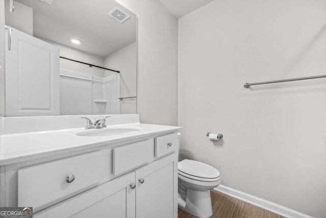 3181 Meadowstone Ln SW, Atlanta, GA 30331 - full bath featuring wood finished floors, baseboards, toilet, vanity, and a shower