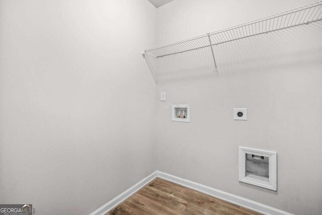 3181 Meadowstone Ln SW, Atlanta, GA 30331 - laundry room with hookup for an electric dryer, hookup for a washing machine, baseboards, and wood finished floors