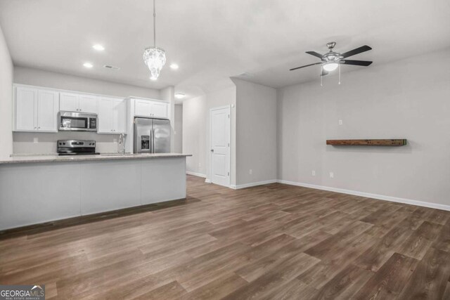 3181 Meadowstone Ln SW, Atlanta, GA 30331 - kitchen featuring appliances with stainless steel finishes, white cabinetry, recessed lighting, dark wood-type flooring, and light countertops