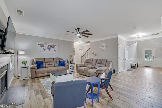 4251 Haywater Cv, Buford, GA 30519 - living area featuring arched walkways, light wood-style floors, a fireplace, stairs, and ceiling fan