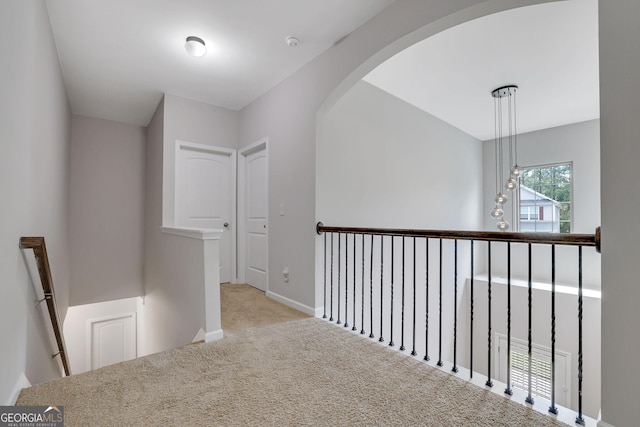 4251 Haywater Cv, Buford, GA 30519 - hall featuring an upstairs landing, carpet flooring, baseboards, and arched walkways