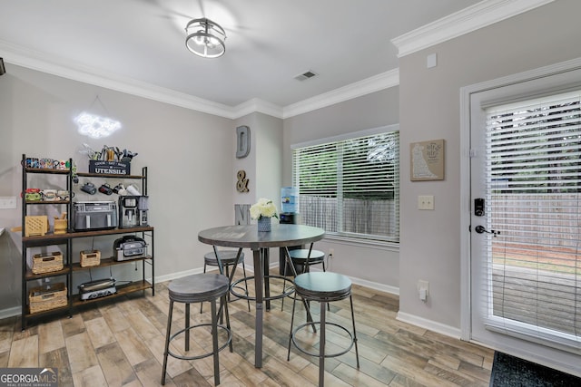 4251 Haywater Cv, Buford, GA 30519 - dining space with light wood finished floors, crown molding, and baseboards