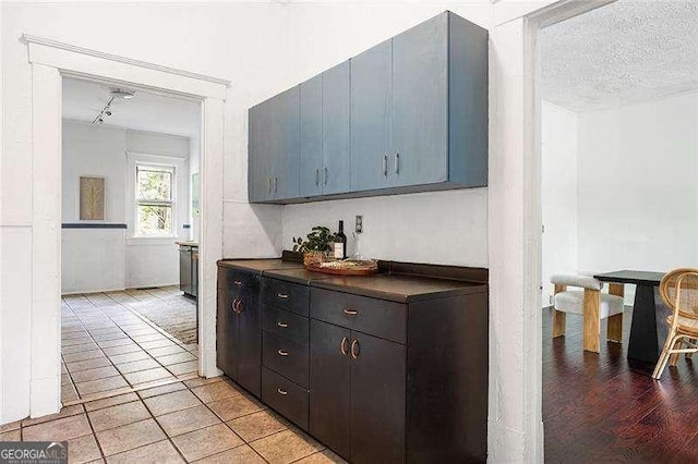 118 Waverly Way, Atlanta, GA 30307 - kitchen featuring dark countertops, a textured ceiling, track lighting, and light tile patterned flooring