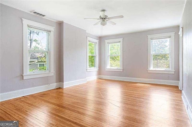118 Waverly Way, Atlanta, GA 30307 - spare room with light wood-type flooring, healthy amount of natural light, ceiling fan, and crown molding