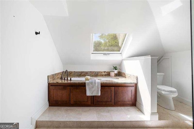 118 Waverly Way, Atlanta, GA 30307 - bathroom featuring toilet, lofted ceiling, and a sink
