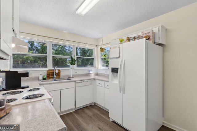 127 Fairfield Dr, Saint Marys, GA 31558 - kitchen featuring white appliances, a sink, a textured ceiling, dark wood-style flooring, and light countertops