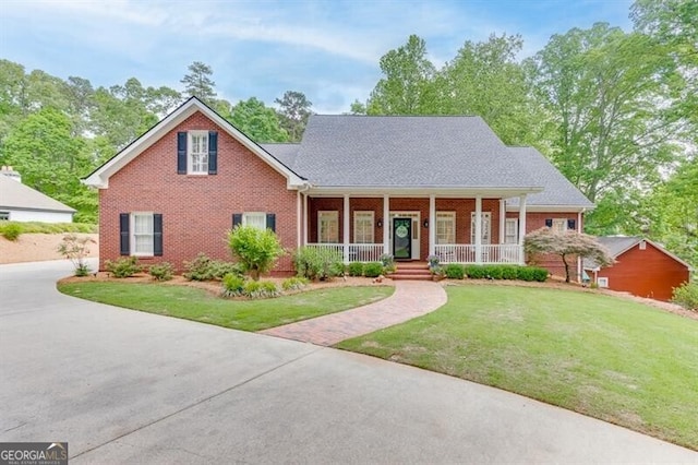 4355 Old Hamilton Mill Rd, Buford, GA 30518 - view of front of property with brick siding, a porch, and a front lawn