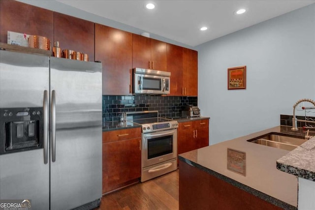 400 W Peachtree St NW Unit 2604, Atlanta, GA 30308 - kitchen with stainless steel appliances, a sink, dark wood-style flooring, dark countertops, and decorative backsplash
