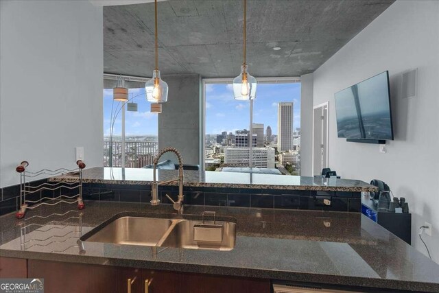 400 W Peachtree St NW Unit 2604, Atlanta, GA 30308 - kitchen with a sink, dark stone countertops, and hanging light fixtures