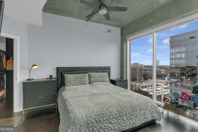 400 W Peachtree St NW Unit 2604, Atlanta, GA 30308 - bedroom featuring wood finished floors, ceiling fan, and a city view