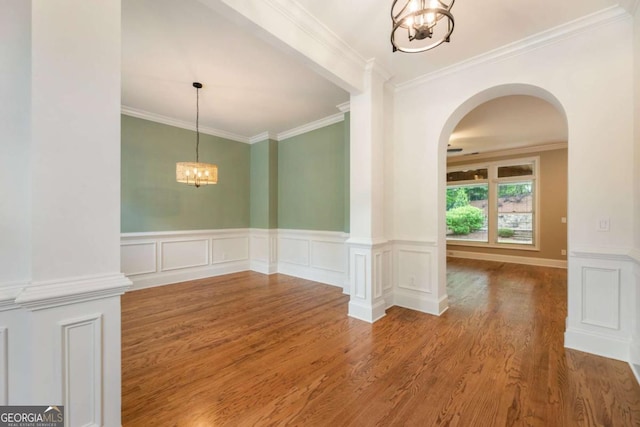 2165 Mcfarlin Ln, Alpharetta, GA 30004 - empty room featuring a chandelier, wood finished floors, arched walkways, ornamental molding, and wainscoting