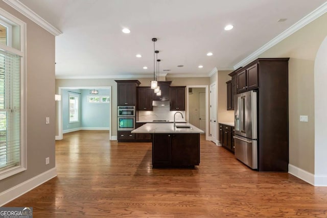 2165 Mcfarlin Ln, Alpharetta, GA 30004 - kitchen featuring stainless steel appliances, dark brown cabinets, light countertops, a kitchen island with sink, and a sink