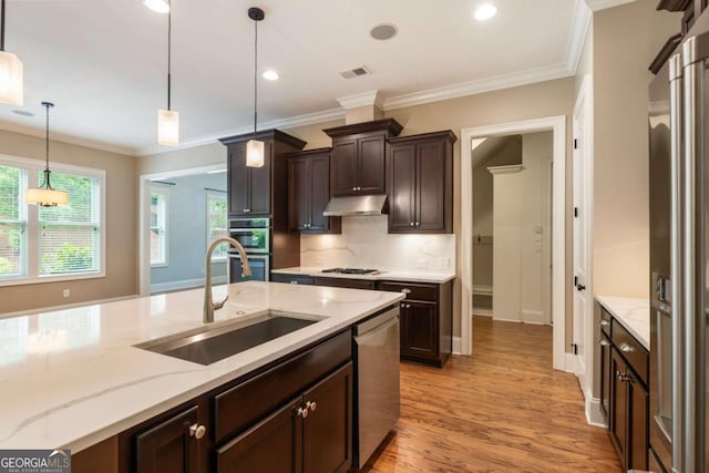 2165 Mcfarlin Ln, Alpharetta, GA 30004 - kitchen with a sink, stainless steel appliances, under cabinet range hood, light wood finished floors, and decorative backsplash