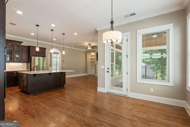 2165 Mcfarlin Ln, Alpharetta, GA 30004 - kitchen with high end refrigerator, ceiling fan, open floor plan, dark brown cabinets, and a kitchen bar