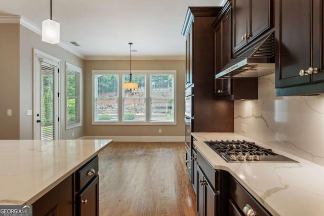 2165 Mcfarlin Ln, Alpharetta, GA 30004 - kitchen with stainless steel gas cooktop, dark brown cabinetry, wood finished floors, under cabinet range hood, and light stone counters