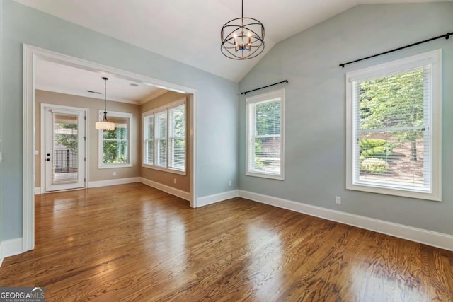 2165 Mcfarlin Ln, Alpharetta, GA 30004 - empty room featuring a chandelier, plenty of natural light, lofted ceiling, wood finished floors, and baseboards