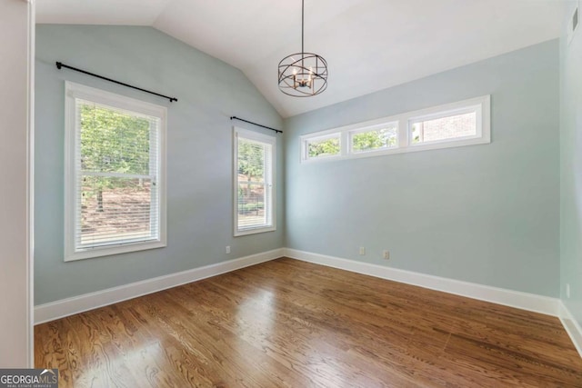 2165 Mcfarlin Ln, Alpharetta, GA 30004 - spare room featuring vaulted ceiling, wood finished floors, a chandelier, and baseboards
