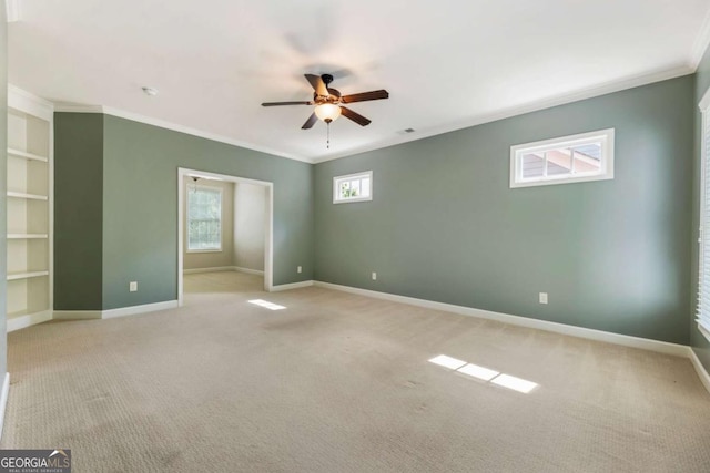 2165 Mcfarlin Ln, Alpharetta, GA 30004 - spare room with crown molding, a ceiling fan, light carpet, baseboards, and built in features