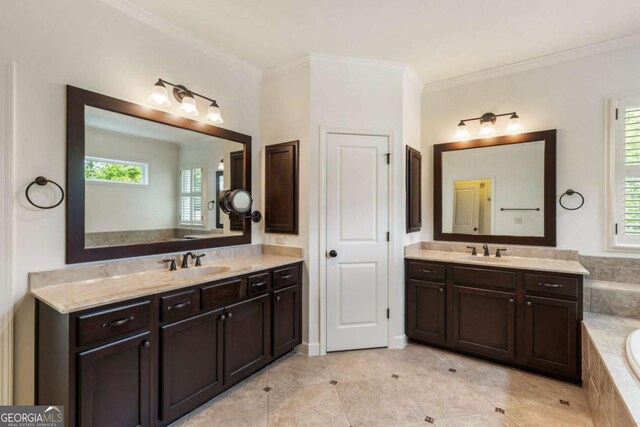 2165 Mcfarlin Ln, Alpharetta, GA 30004 - bathroom featuring two vanities, ornamental molding, a garden tub, and tile patterned floors