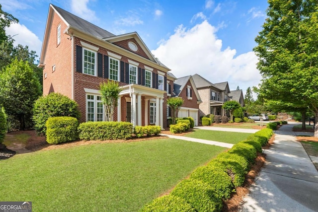 2165 Mcfarlin Ln, Alpharetta, GA 30004 - colonial home featuring brick siding, a front lawn, and concrete driveway