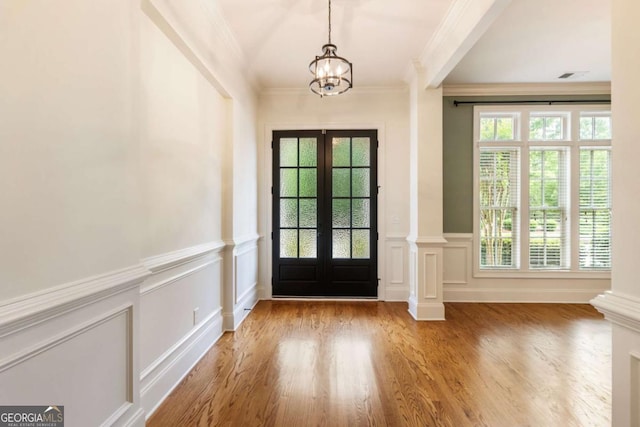 2165 Mcfarlin Ln, Alpharetta, GA 30004 - entrance foyer with french doors, ornamental molding, a decorative wall, a chandelier, and healthy amount of natural light