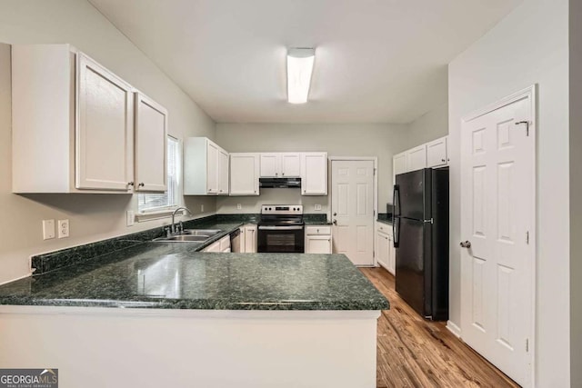 558 Elbridge Dr NW, Atlanta, GA 30318 - kitchen featuring range with electric stovetop, freestanding refrigerator, under cabinet range hood, a peninsula, and wood finished floors