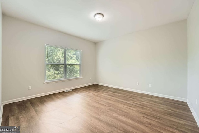 558 Elbridge Dr NW, Atlanta, GA 30318 - spare room featuring dark wood-style floors